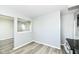 An empty living room with light gray walls and light wood flooring at 1216 N Whittier Pl, Indianapolis, IN 46219