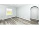 Comfortable living room with gray wood floors and fresh gray paint at 1216 N Whittier Pl, Indianapolis, IN 46219