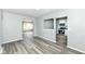 Modern living room with gray wood floors and seamless transitions to the kitchen at 1216 N Whittier Pl, Indianapolis, IN 46219
