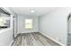 Cozy living space with gray wood flooring and neutral gray wall paint at 1216 N Whittier Pl, Indianapolis, IN 46219