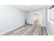 Spacious living area featuring gray wood floors and seamless transitions to other rooms at 1216 N Whittier Pl, Indianapolis, IN 46219