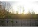 Backyard wooden fence decorated with hanging plants and a bird house at 12214 Cold Stream Rd, Noblesville, IN 46060