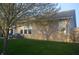 Well-maintained backyard features a charming outdoor seating area, lush green lawn, and mature trees at 12214 Cold Stream Rd, Noblesville, IN 46060
