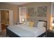 Comfortable bedroom with a spacious bed, natural lighting, and a Primary bathroom entrance at 12214 Cold Stream Rd, Noblesville, IN 46060