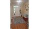 Inviting foyer with natural light, hardwood floors, a colorful rug, and a charming bench for added style and function at 12214 Cold Stream Rd, Noblesville, IN 46060