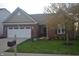 Charming brick home featuring an attached two-car garage, well-manicured lawn and mature landscaping at 12214 Cold Stream Rd, Noblesville, IN 46060