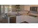 Well-lit kitchen featuring stainless appliances, a breakfast bar, granite counters and a view into dining area at 12214 Cold Stream Rd, Noblesville, IN 46060