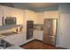 Modern kitchen with stainless steel appliances, granite countertops, white cabinetry, and wood floors at 12214 Cold Stream Rd, Noblesville, IN 46060