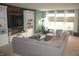 Cozy living room featuring a large sectional sofa, built-in shelving, and plenty of natural light at 12214 Cold Stream Rd, Noblesville, IN 46060