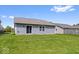 View of the backyard with a sliding glass door and well-maintained lawn at 123 Thistlewood Dr, Greenfield, IN 46140