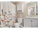 Updated bathroom features floral shower curtain and modern vanity at 123 Thistlewood Dr, Greenfield, IN 46140