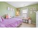 Well-lit bedroom with green walls and playful decor at 123 Thistlewood Dr, Greenfield, IN 46140