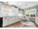 Bright kitchen breakfast nook featuring a built-in bench, table seating, and views to the backyard at 123 Thistlewood Dr, Greenfield, IN 46140