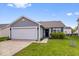 Charming single-story home featuring a well-maintained lawn and an attached two-car garage at 123 Thistlewood Dr, Greenfield, IN 46140