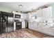 Updated kitchen featuring stainless steel appliances, white cabinetry, and subway tile backsplash at 123 Thistlewood Dr, Greenfield, IN 46140