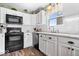Beautiful kitchen with black appliances and white cabinets at 123 Thistlewood Dr, Greenfield, IN 46140