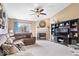 Inviting living room with a cozy fireplace, comfortable seating, and a ceiling fan at 123 Thistlewood Dr, Greenfield, IN 46140