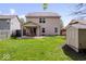 Exterior of the home showcasing a fenced backyard, a covered patio, and a small storage shed at 132 Thistlewood Dr, Greenfield, IN 46140
