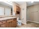 Well-lit bathroom features a vanity with a sink, toilet, and shower, offering a functional and clean space at 132 Thistlewood Dr, Greenfield, IN 46140