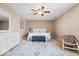 Spacious bedroom with a ceiling fan, patterned rug, and neutral-toned walls provides a relaxing atmosphere at 132 Thistlewood Dr, Greenfield, IN 46140