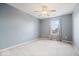 Bright and spacious room with neutral carpet, blue walls, a ceiling fan and lots of natural light at 132 Thistlewood Dr, Greenfield, IN 46140
