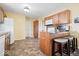 Functional kitchen with warm wood cabinetry and a breakfast bar at 132 Thistlewood Dr, Greenfield, IN 46140