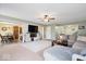 Open-concept living room flowing into the dining area with a stylish media center and comfortable seating at 132 Thistlewood Dr, Greenfield, IN 46140