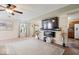 Cozy living room featuring a wall-mounted television, modern fireplace and a sectional sofa at 132 Thistlewood Dr, Greenfield, IN 46140