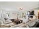 Bright living room with a large sectional, modern decor, and an adjacent dining space at 132 Thistlewood Dr, Greenfield, IN 46140