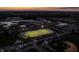 Aerial view of a high school football field illuminated at sunset, packed with cheering fans at 13797 E Southshore Dr, Fishers, IN 46037