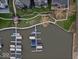 Aerial view showcasing boat docks by the water, manicured lawns, walkways, and landscaping within the neighborhood at 13797 E Southshore Dr, Fishers, IN 46037