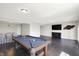 Finished basement with a pool table, entertainment area, and dark wood flooring at 13797 E Southshore Dr, Fishers, IN 46037