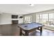 Spacious basement featuring a pool table, media console, and access to outdoor patio at 13797 E Southshore Dr, Fishers, IN 46037