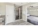 Bathroom featuring shower, dual vanity sinks, and view to the main bedroom at 13797 E Southshore Dr, Fishers, IN 46037