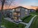 The rear of the home features brick accents, dual balconies and a patio perfect for entertaining or relaxing by the garden at 13797 E Southshore Dr, Fishers, IN 46037