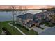 A luxury two-story home with a two car garage, brick accents, professional landscaping, and waterfront views at 13797 E Southshore Dr, Fishers, IN 46037