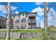 Three-story building showing patios, lawn and retaining wall at 13797 E Southshore Dr, Fishers, IN 46037