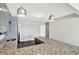 Open kitchen layout featuring a breakfast bar with granite countertops and modern lighting fixtures at 13797 E Southshore Dr, Fishers, IN 46037