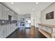 Modern kitchen features grey cabinetry, stainless steel appliances, and an adjacent dining area at 13797 E Southshore Dr, Fishers, IN 46037