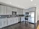 Well-equipped kitchen featuring gray cabinets, stainless steel appliances, and a stylish backsplash at 13797 E Southshore Dr, Fishers, IN 46037