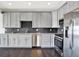 Modern kitchen featuring gray cabinets, stainless steel appliances, and a stylish backsplash at 13797 E Southshore Dr, Fishers, IN 46037