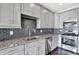 Well-equipped kitchen features gray cabinets, stainless steel appliances, and a stylish backsplash at 13797 E Southshore Dr, Fishers, IN 46037