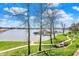 Scenic lake view of recreation area featuring lakeside dock, path with covered seating on a bright sunny day at 13797 E Southshore Dr, Fishers, IN 46037