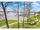 Expansive lake view featuring lakeside recreation area, dock and path with covered seating on a sunny day at 13797 E Southshore Dr, Fishers, IN 46037