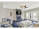 Comfortable living room with a blue and white rug, fireplace, ceiling fan, and access to the outdoor space at 13797 E Southshore Dr, Fishers, IN 46037