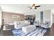 Bright living room with white sofa and chairs, complemented by a stylish blue rug and modern ceiling fan at 13797 E Southshore Dr, Fishers, IN 46037