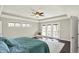 Spacious main bedroom with decorative ceiling fan and view of private balcony at 13797 E Southshore Dr, Fishers, IN 46037