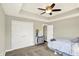 Comfortable bedroom featuring a tray ceiling, neutral walls, and carpet flooring at 13797 E Southshore Dr, Fishers, IN 46037
