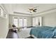 Bright main bedroom features coffered ceiling, ceiling fan, sitting area, and access to a private balcony at 13797 E Southshore Dr, Fishers, IN 46037