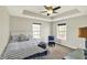 Cozy main bedroom with tray ceiling, carpet floors, and natural light at 13797 E Southshore Dr, Fishers, IN 46037